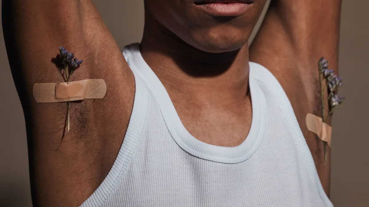 Does natural deodorant cause underarm detox symptoms? Woman with bandaged armpits and dried herbs