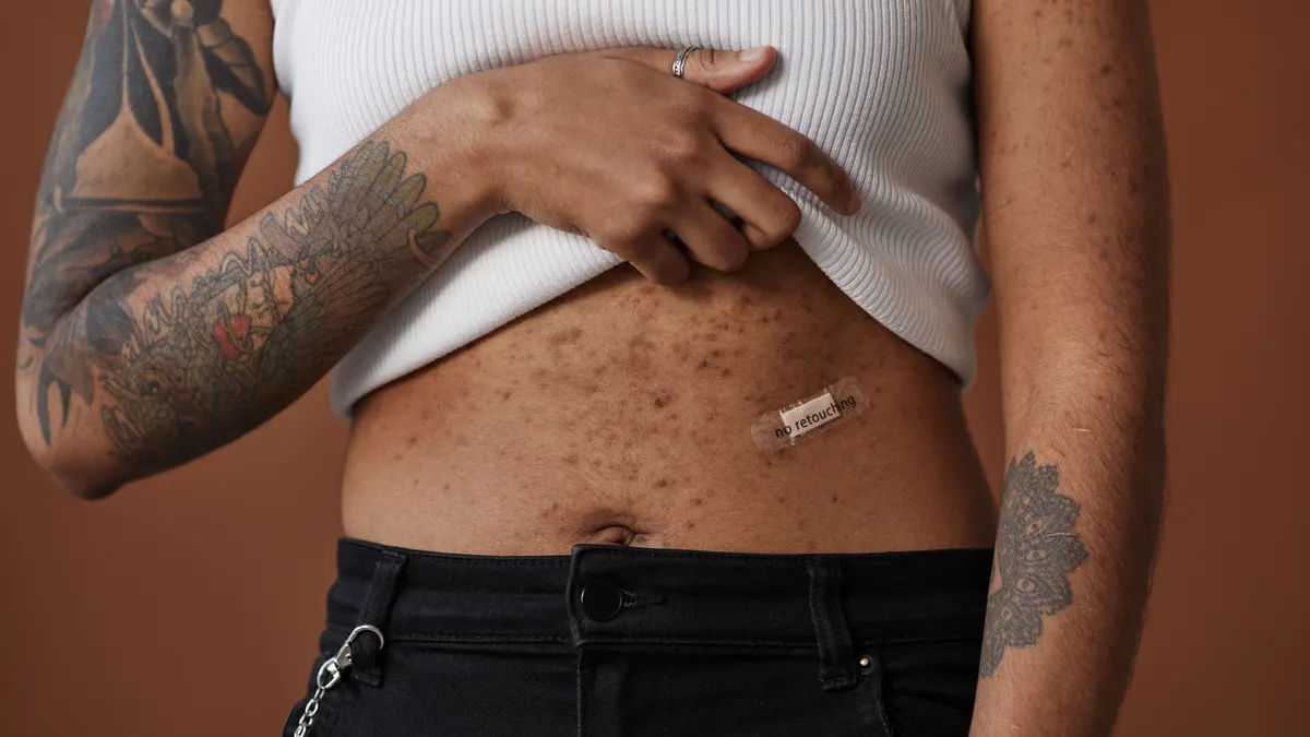 Person applying a small patch to skin on the torso